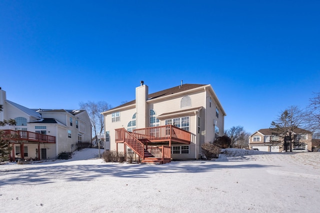 snow covered property with a deck