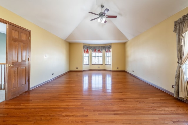 unfurnished room with lofted ceiling, ceiling fan, and light wood-type flooring