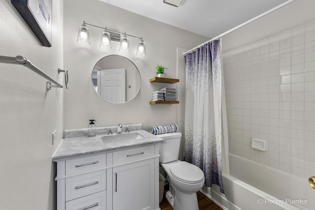 full bathroom featuring toilet, hardwood / wood-style floors, vanity, and shower / bath combo with shower curtain