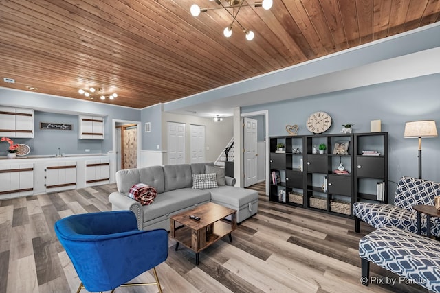 living room featuring hardwood / wood-style floors, a chandelier, and wooden ceiling