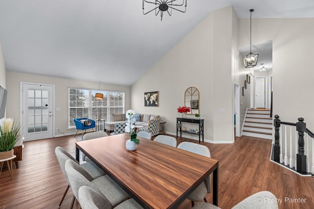 dining space with a chandelier, dark hardwood / wood-style flooring, and high vaulted ceiling