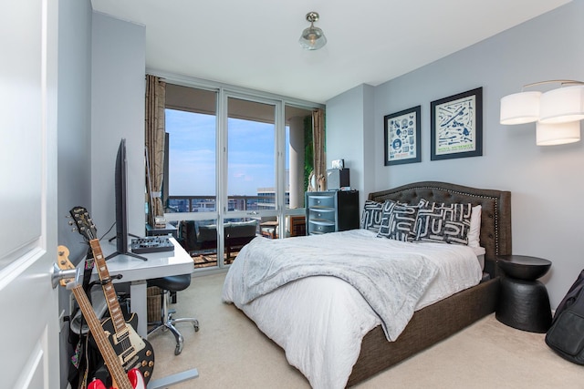 carpeted bedroom featuring floor to ceiling windows