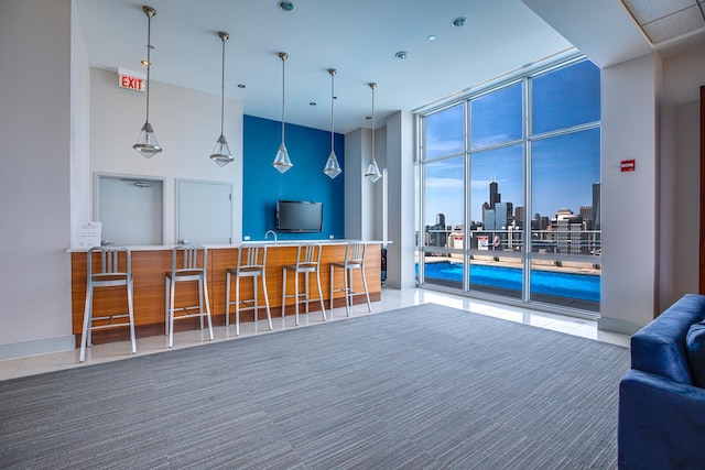 living room featuring floor to ceiling windows and a high ceiling