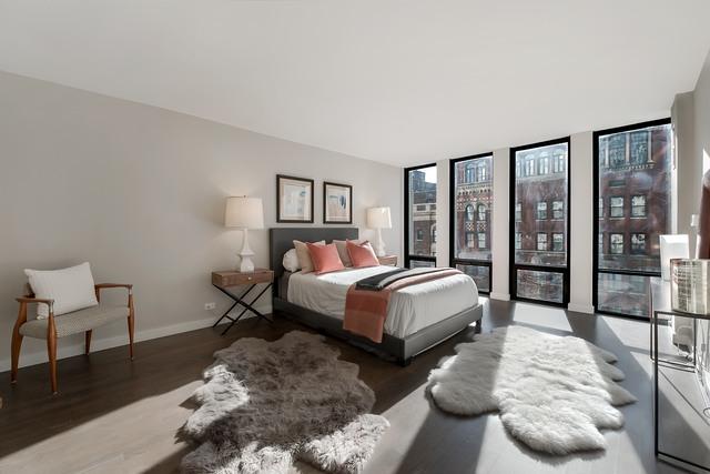 bedroom featuring expansive windows, access to exterior, and dark hardwood / wood-style floors