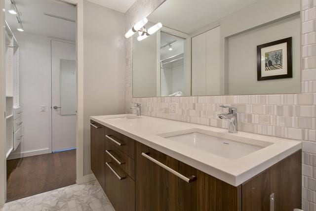 bathroom with decorative backsplash and vanity