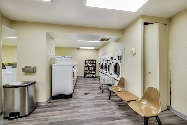 laundry room featuring light hardwood / wood-style floors and washer and clothes dryer