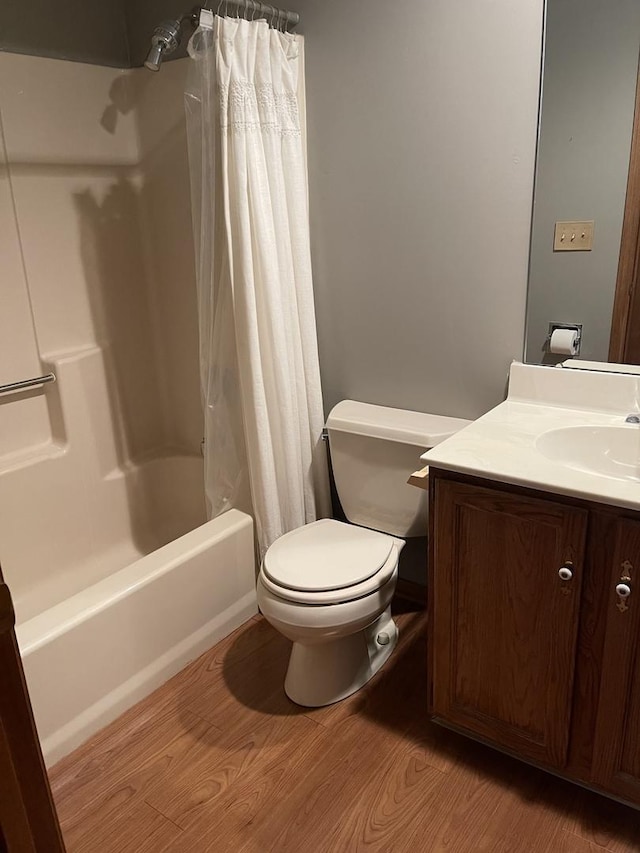 full bathroom featuring toilet, vanity, shower / bathtub combination with curtain, and hardwood / wood-style floors