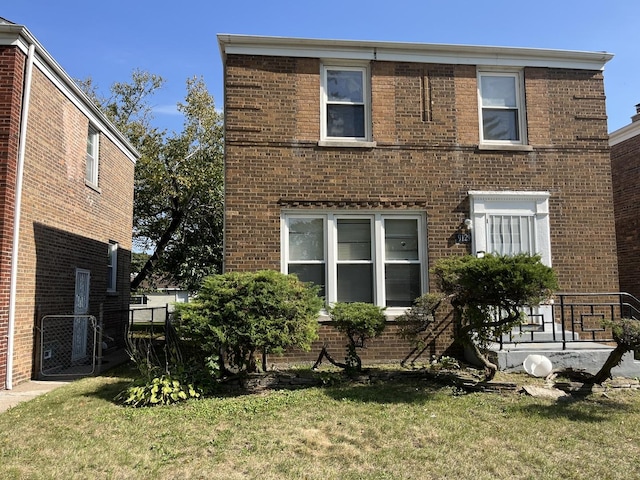 rear view of property with a lawn