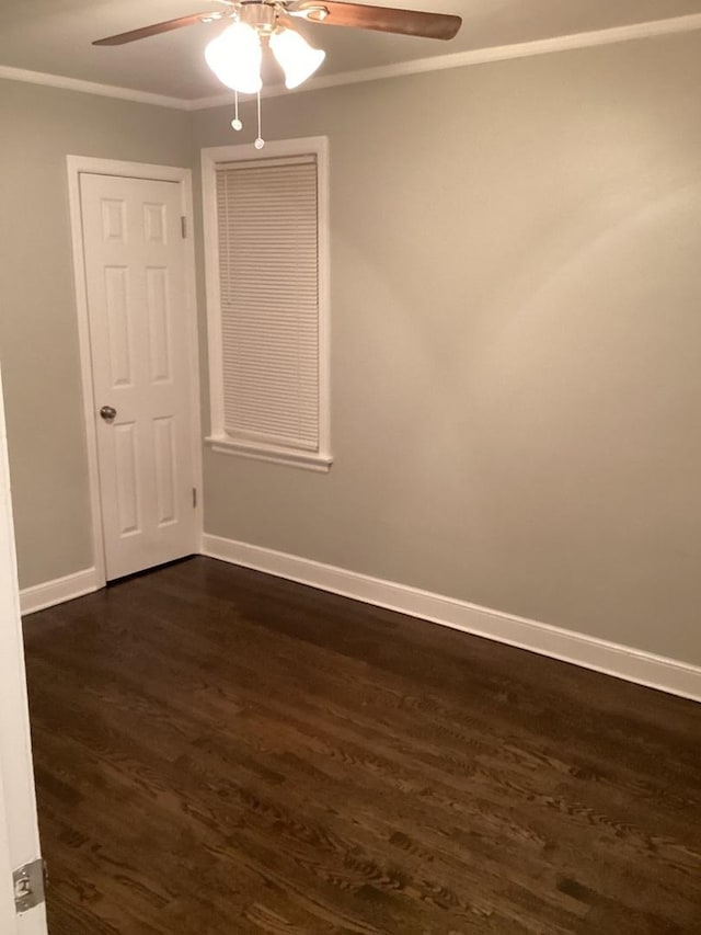 spare room with ornamental molding, dark hardwood / wood-style floors, and ceiling fan