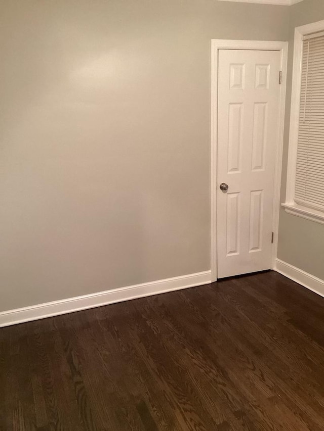 unfurnished room with dark hardwood / wood-style floors