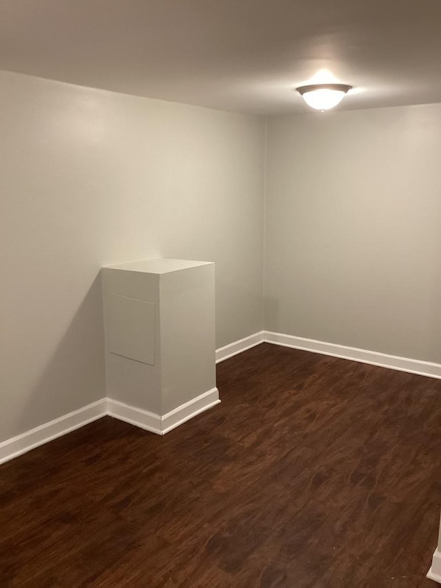 spare room featuring dark hardwood / wood-style flooring