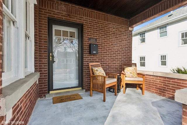 doorway to property with brick siding