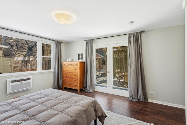 bedroom with baseboards, wood finished floors, access to exterior, an AC wall unit, and french doors