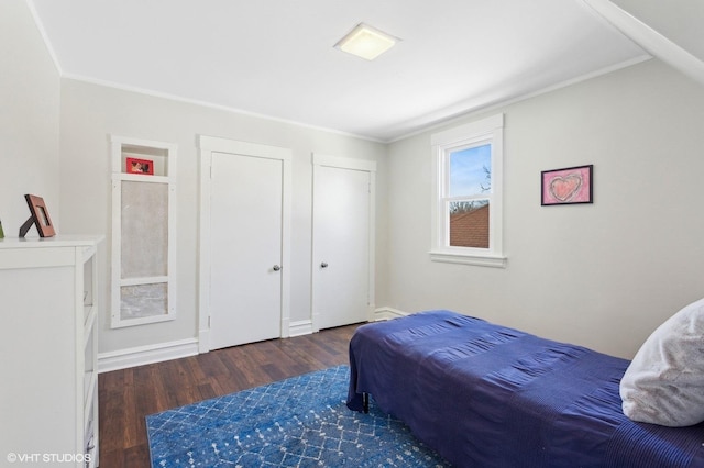 bedroom featuring crown molding and wood finished floors