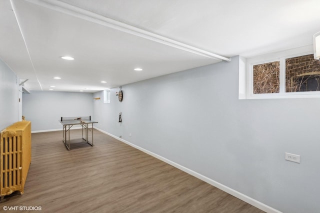 interior space featuring baseboards, recessed lighting, wood finished floors, and radiator