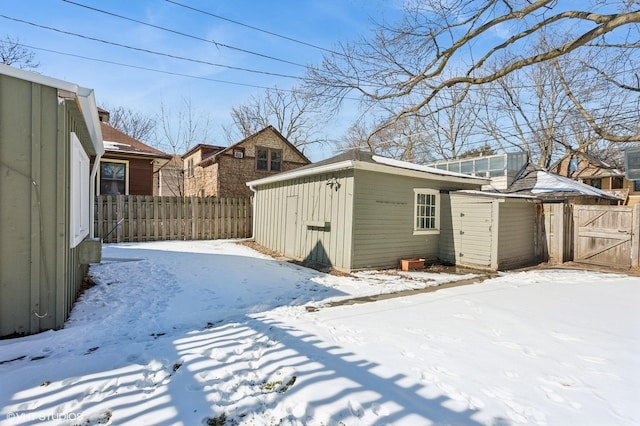 exterior space featuring an outbuilding, board and batten siding, and fence