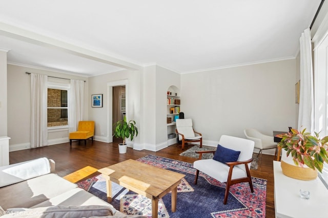 living area featuring built in features, baseboards, wood finished floors, and ornamental molding