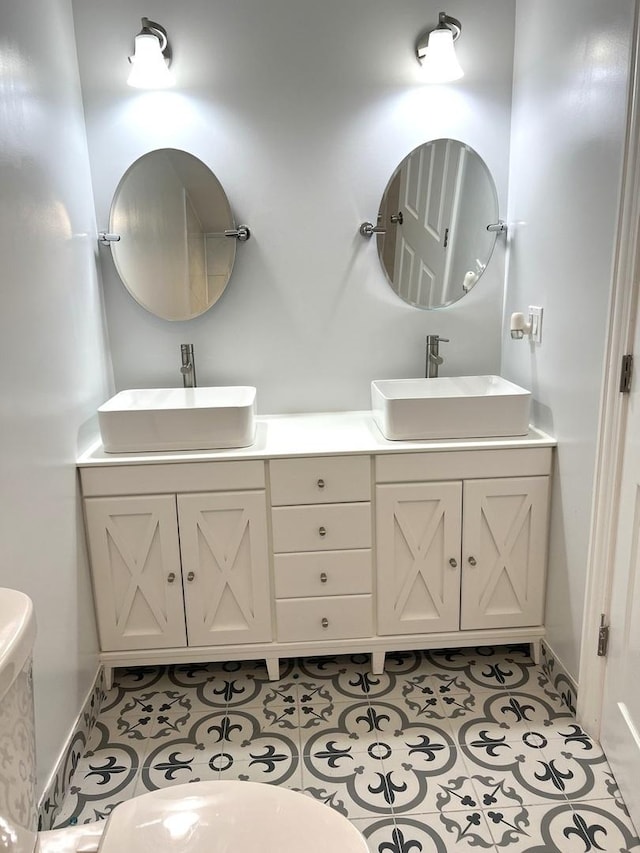 bathroom featuring toilet, tile patterned floors, and vanity