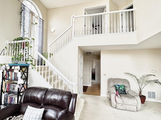 interior space featuring carpet floors and a high ceiling