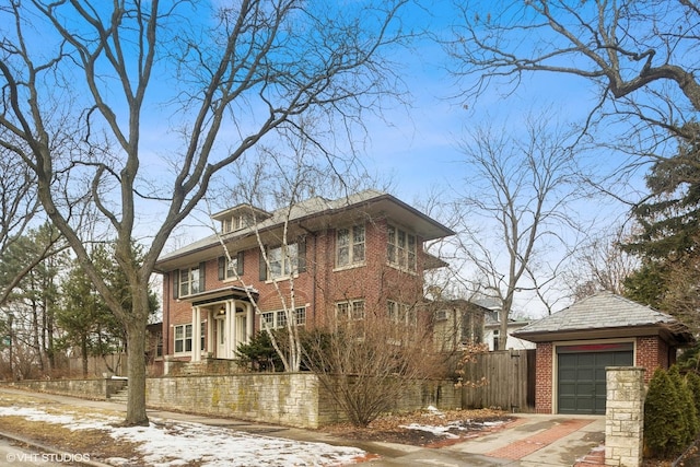 view of front of house featuring brick siding, fence, and an outdoor structure