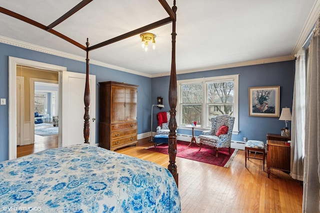 bedroom with crown molding, multiple windows, and hardwood / wood-style floors