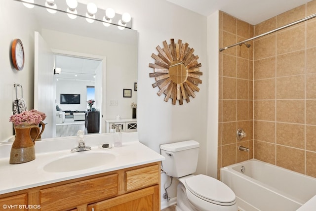 bathroom featuring toilet, shower / washtub combination, and vanity