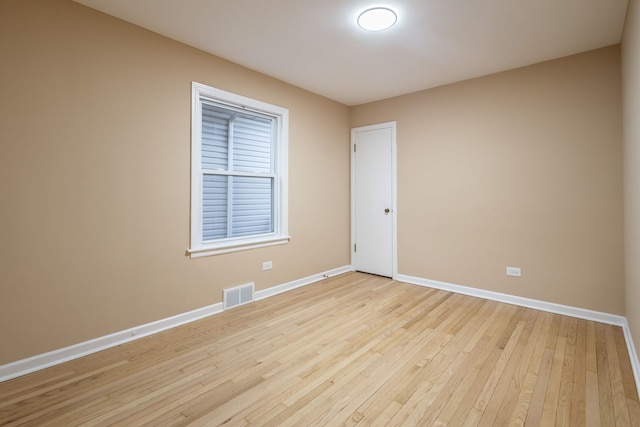 spare room with light hardwood / wood-style flooring