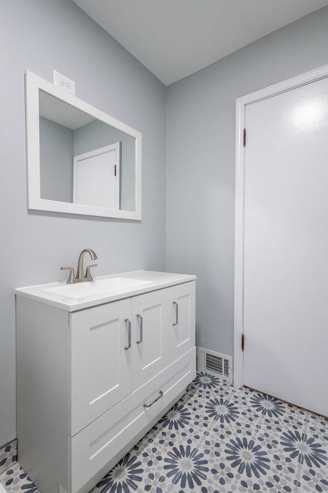 bathroom with tile patterned floors and vanity