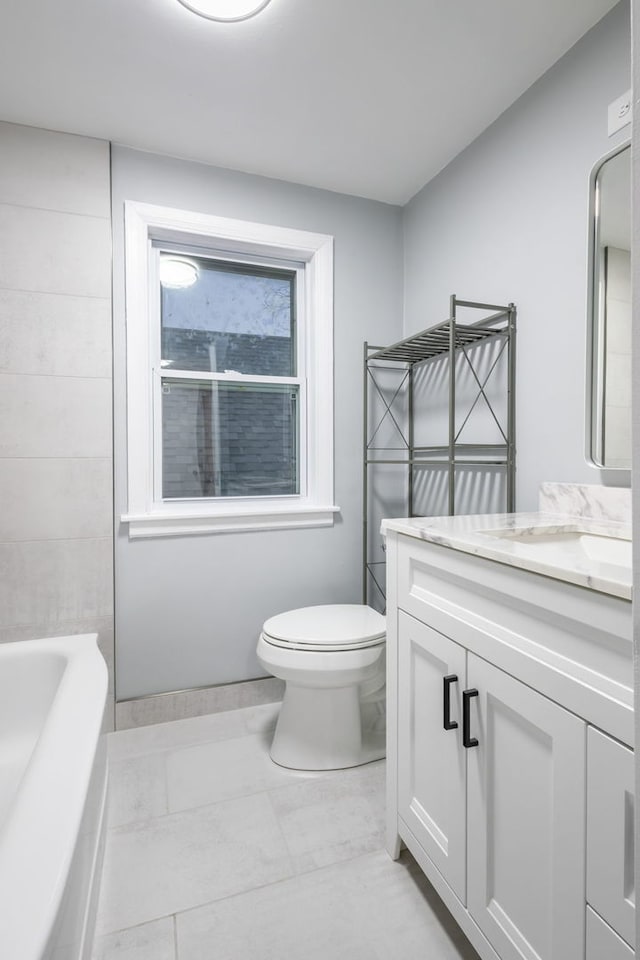 bathroom featuring vanity, toilet, and tile patterned floors