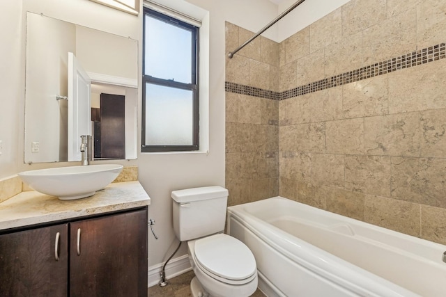 full bathroom with tiled shower / bath, vanity, and toilet