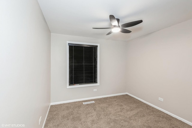 spare room featuring ceiling fan and carpet flooring