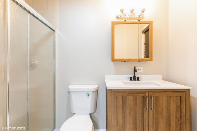 bathroom featuring vanity, toilet, and an enclosed shower