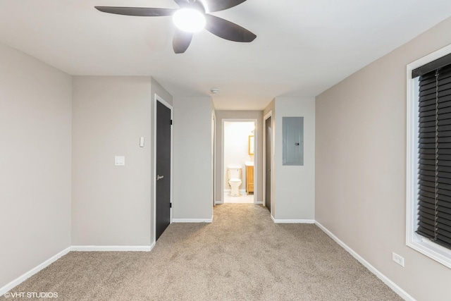 empty room with ceiling fan, electric panel, and light carpet