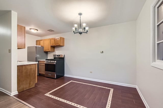 kitchen with appliances with stainless steel finishes and a chandelier