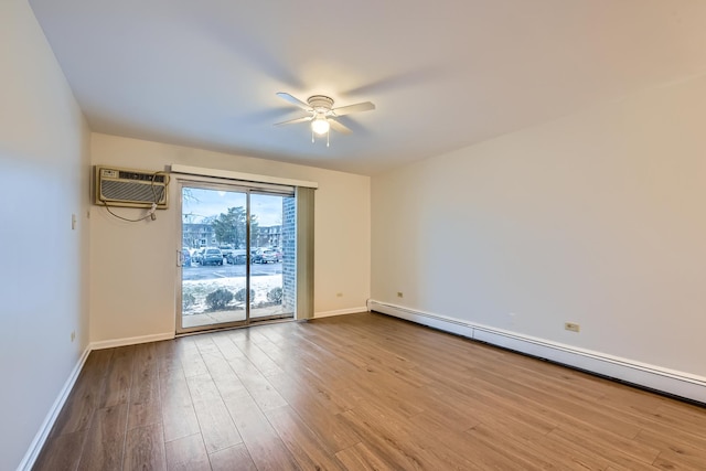 spare room featuring ceiling fan, a baseboard heating unit, light hardwood / wood-style flooring, and a wall unit AC