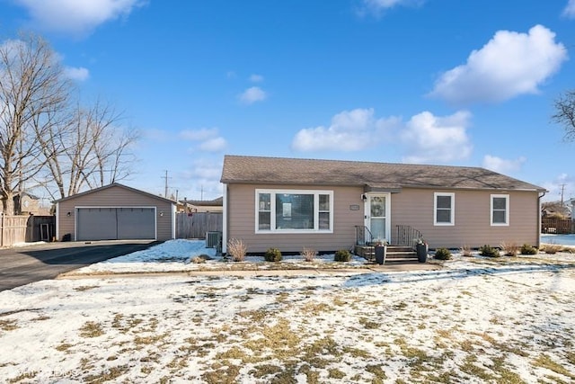 single story home with central AC unit, an outdoor structure, and a garage