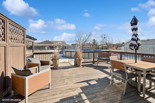 wooden terrace with a covered pool