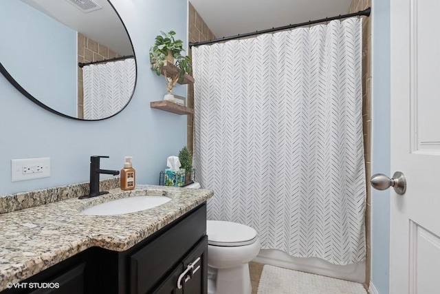 bathroom with toilet and vanity