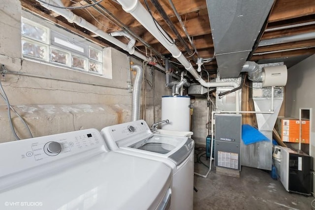 clothes washing area featuring washing machine and clothes dryer and gas water heater