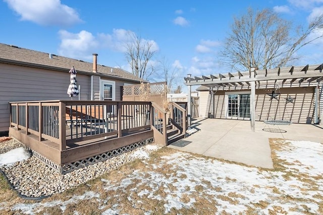 snow covered deck with a pergola and a patio