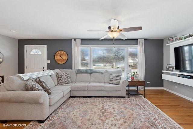 living room featuring ceiling fan and hardwood / wood-style floors