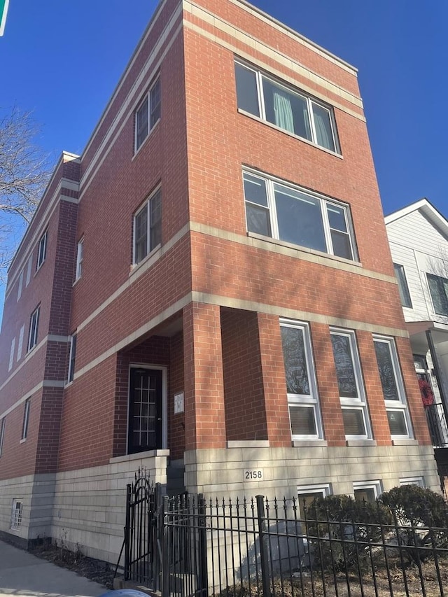 view of building exterior featuring a fenced front yard