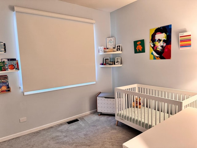 carpeted bedroom with a nursery area and baseboards