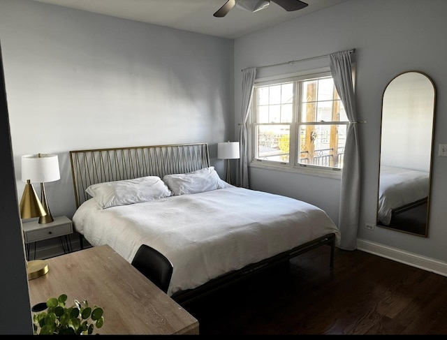 bedroom featuring a ceiling fan, dark wood finished floors, and baseboards