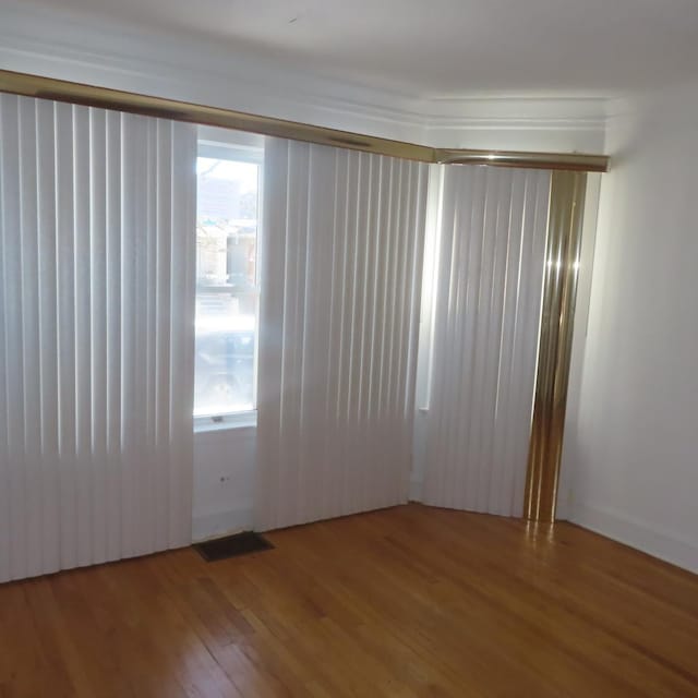 spare room with hardwood / wood-style flooring