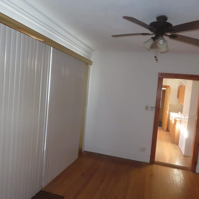 unfurnished room featuring ceiling fan and hardwood / wood-style floors