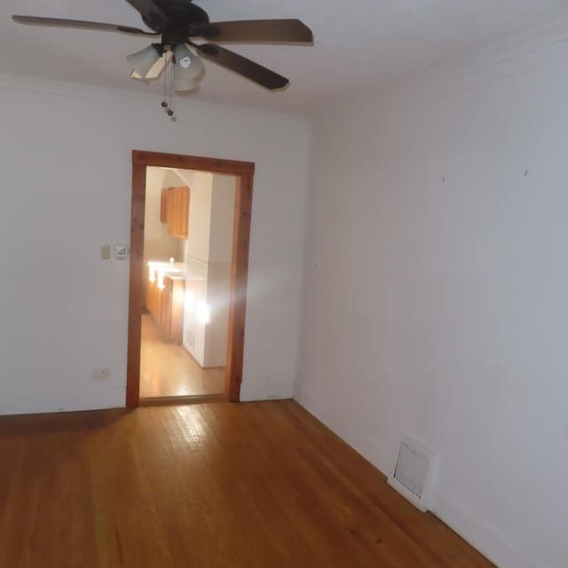 empty room featuring ceiling fan and hardwood / wood-style flooring