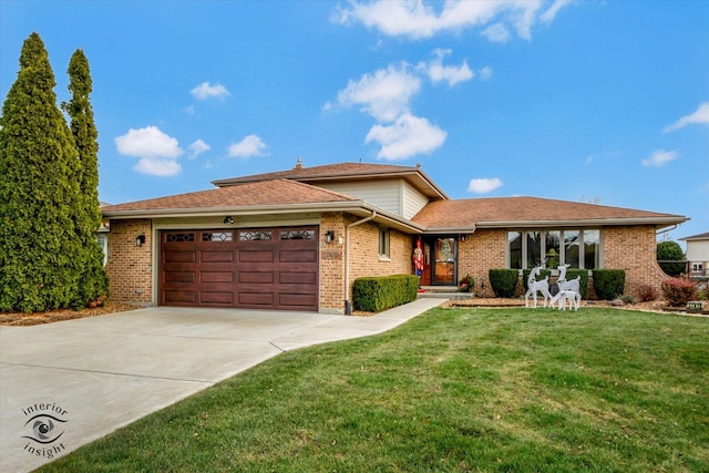 view of front facade with a garage and a front lawn