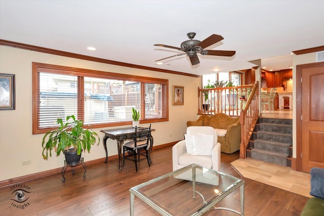 living room featuring ceiling fan, hardwood / wood-style flooring, and crown molding