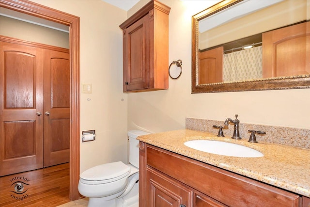 bathroom featuring toilet and vanity